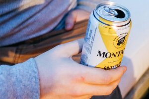 Man seated holding a can of beer at 168极速赛车官方开奖结果记录体彩 Resort