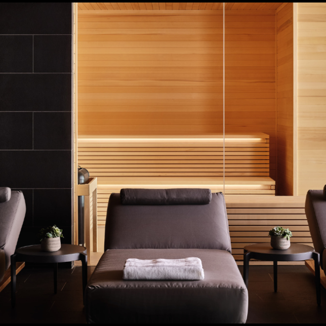 Three gray lounge chairs lined up with the sauna in the background at the 极速赛车168一分钟开奖记录体彩-开奖结果预测官网直播 seawater spa BathHouse